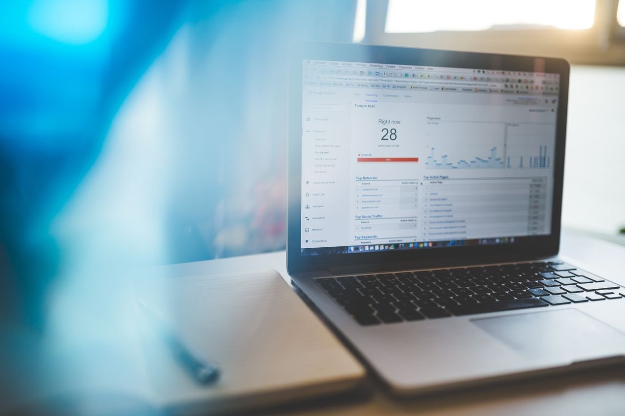 Mastering the First Impression: Your intriguing post title goes here Laptop displaying Google Analytics in a modern workspace, highlighting digital analytics and technology.